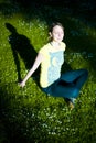 Sunlit woman in shadowy park