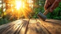 Sunlit wooden table with hand using hammer in forest scene Royalty Free Stock Photo