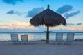 Sunlounge chairs and umbrella on the sunset beach in Florida Key Royalty Free Stock Photo