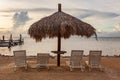 Sunlounge chairs and umbrella on the sunset beach in Florida Keys Royalty Free Stock Photo
