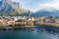 Sunny aerial cityscape of Lecco town on spring morning. Picturesque waterfront of Lecco town located between famous Lake Como and