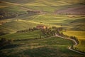 Farmhouse in the green and golden hills of Val d`Orcia Royalty Free Stock Photo