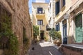 This sunny alley with many flower pots and a sleeping cat in Aggelou street exudes tranquility in the old town of Chania, Crete Royalty Free Stock Photo