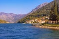 Sunny autumn day, beautiful Mediterranean landscape with small seaside village against mountains.  Montenegro Royalty Free Stock Photo