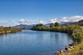 On a sunny Autumn day in Northwestern Idaho, a river flows peacefully with mountains in the distance.