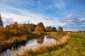 Sunny autumn day on river and meadow. Colorful landscape with forest, field, lake Royalty Free Stock Photo