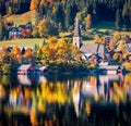 Sunny autumn view of Heiliger Agidius - Catholic church. Colorful morning scene of Altaussee village. Nice landscape of Altausseer