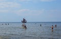 Sunny beach and blue water and a pleasure boat on the shore of the Gulf of Riga. 29, July, 2018, Latvia, Jurmala