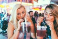 SUNNY BEACH, BULGARIA, AUGUST 29, 2015: Party girls on the Flower street drink cocktails.