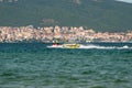 Sunny Beach, Bulgaria July 13, 2019. An inflatable pontoon with people holding onto it, towed by a water scooter on the Black Sea