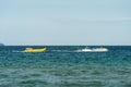 Sunny Beach, Bulgaria July 13, 2019. Inflatable recreational banana boat with people towed by a motorboat in the Black Sea on the