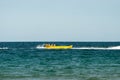 Sunny Beach, Bulgaria July 13, 2019. Inflatable recreational banana boat with people towed by a motorboat in the Black Sea on the