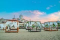 Sunny Beach, Bulgaria - 4 Sep 2018: Umbrellas and chair lounges at sunrise in Sunny Beach, a major seaside resort on the Black Sea