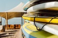 Sunny Beach Campsite: Colorful Surfboard Stack with Ocean View.