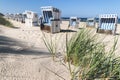 Beach scene with marram grass and defocused chairs on Sylt island Royalty Free Stock Photo