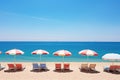 Sunny beach landscape with striped umbrellas and lounging chairs Royalty Free Stock Photo