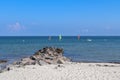Sunny beach life with some people in the distance in Schoenberg in northern Germany Royalty Free Stock Photo