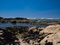 Sunny beach with rock pools on summer day in Portugal Royalty Free Stock Photo