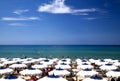 Sunny Beach with White and Blue Umbrellas in Italy