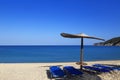 Sunny beach with wicker umbrella