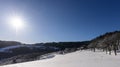 Sunny blue clear idyllic winter rural landscape scene over a snow field Royalty Free Stock Photo