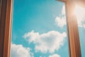Sunny blue sky view through wooden window frame on a clear day Royalty Free Stock Photo