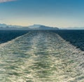 Sunny bright panorama of turbulent ship wash in the vast ocean channel of Stephen`s Passage, Alaska, USA Inside Passage. Royalty Free Stock Photo