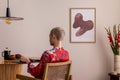 Sunny and bright space of living room with mock up poster frame, woman in red kimono, bouquet flower in vase and personal Royalty Free Stock Photo