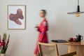 Sunny and bright space of living room with mock up poster frame, woman in red kimono, bouquet flower in vase and personal Royalty Free Stock Photo