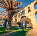 Sunny cityscape of Kavala town with medieval aqueduct Kamares.