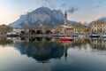 Sunny cityscape of Lecco town on spring day. Picturesque waterfront of Lecco town located between famous Lake Como and scenic