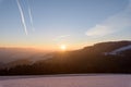 Sunny clear winter sunrise landscape over a snow field, valley and hills with blue sky Royalty Free Stock Photo