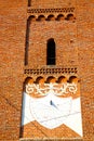 In the sunny clock closed brick tower italy lombardy Royalty Free Stock Photo