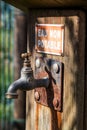 Sunny closeup of rusted faucet with non drinkable warning water Royalty Free Stock Photo