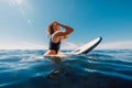 Sunny day with attractive surf girl waiting waves on surfboard in sea Royalty Free Stock Photo