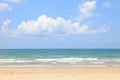 Sunny day at the beach with bright blue sky and fluffy white cloud on the sea horizon with copy space Royalty Free Stock Photo