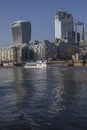 Sunny day, blue skies and shiny waters of the river Thames; The City of London in the background.