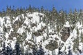Sunny Day Blue Sky Above Powder Covered Winter Landscape with Snow on Rocky Cliff
