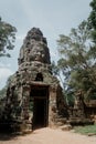 Sunny day at East entrance gate to Angkor Thom with smiling faces at top Royalty Free Stock Photo