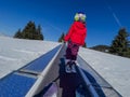 Sunny day for girl's first ski lesson on magic carpet Royalty Free Stock Photo