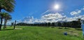 Sunny day.  Green field.  Clouds.  Sky. Hot Royalty Free Stock Photo