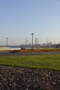 Sunny day with green grass and blue sky. Young trees. Reidi tee promenade. Modern space for walking and rest in a city