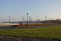 Sunny day with green grass and blue sky. Young trees. Reidi tee promenade. Modern space for walking and rest in a city