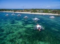 Sunny Day in Malapascua Island in Visayan Sea, One of Cebu Island. Sea water and Boats. Bounty Beach with Local Architecture Royalty Free Stock Photo