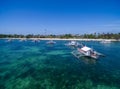 Sunny Day in Malapascua Island in Visayan Sea, One of Cebu Island. Sea water and Boats. Bounty Beach with Local Architecture Royalty Free Stock Photo