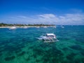 Sunny Day in Malapascua Island in Visayan Sea, One of Cebu Island. Sea water and Boats. Bounty Beach with Local Architecture Royalty Free Stock Photo