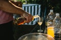 On a sunny day, a man pours wine in the boklah outdoors Royalty Free Stock Photo