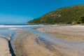 Sunny day at Matadeiro beach with mountains and ocean in Florianopolis Royalty Free Stock Photo