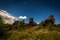 Sunny day on Obri skaly under peak Serak in Jeseniky with green grass pine tree and dark blue cloudy sky Royalty Free Stock Photo