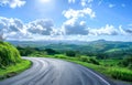 Sunny Day Over a Curved Country Road in a Lush Green Landscape Royalty Free Stock Photo